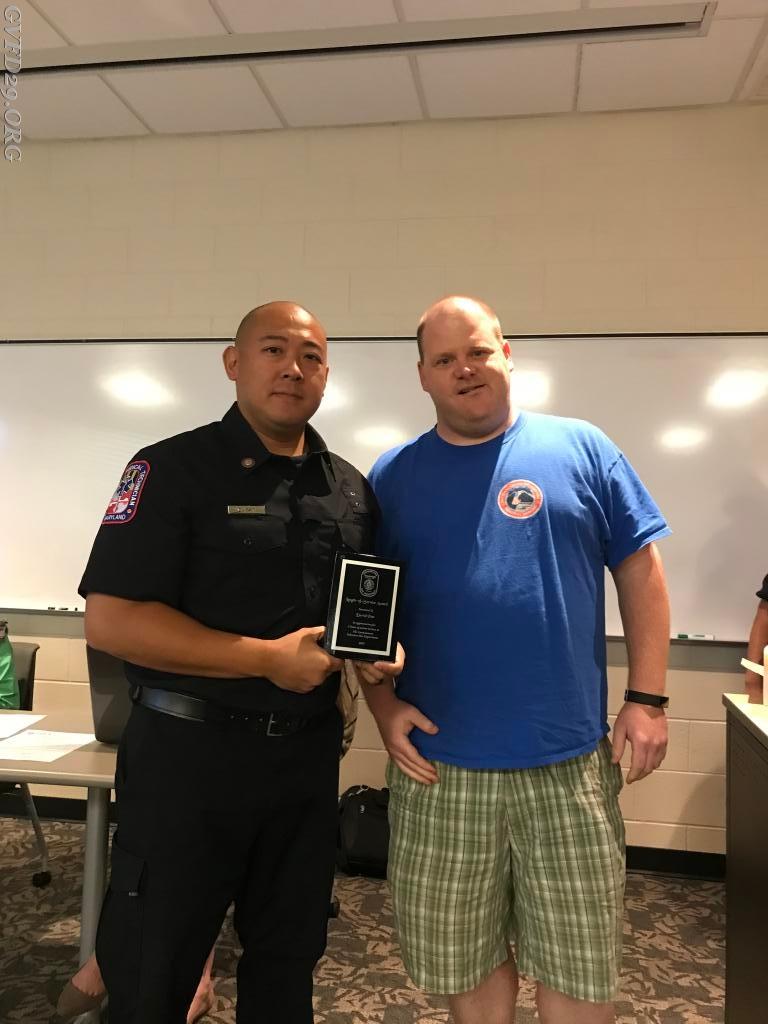 Past President Hermanson presents EMS Provider II David Pan with a plaque for 5 years of Service to the Germantown Volunteer Fire Department.