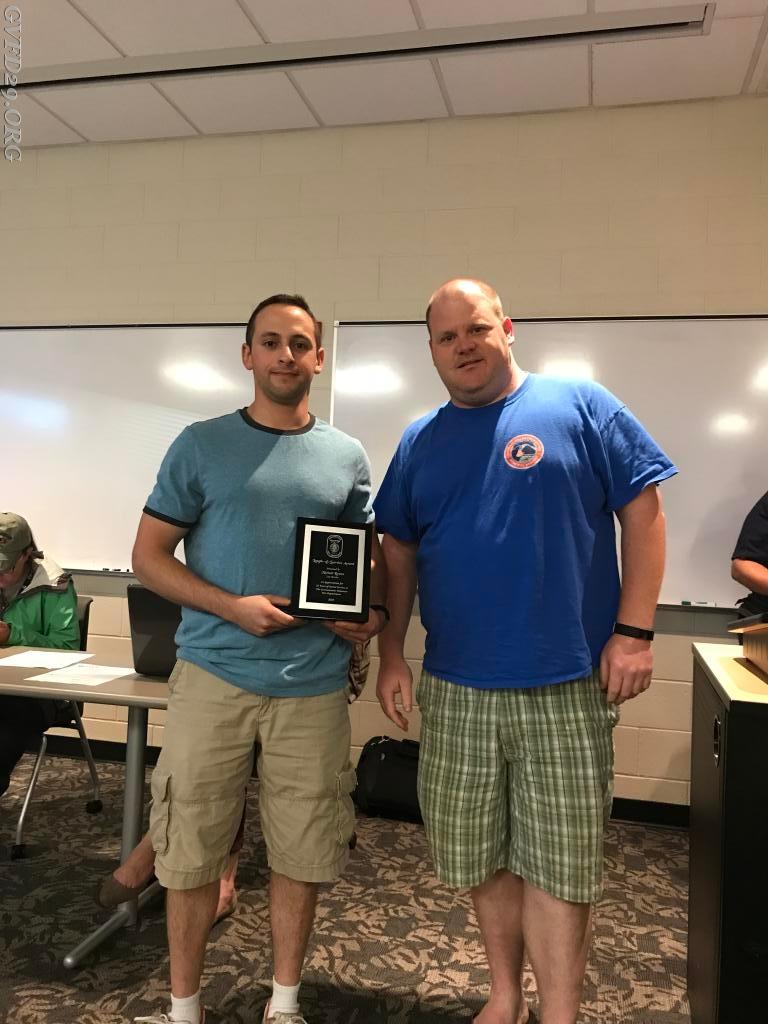 Past President Hermanson presents a plaque to Master EMS Provider Michael C Rossen recognizing him  a Life Member of the Germantown Volunteer Fire Department. 